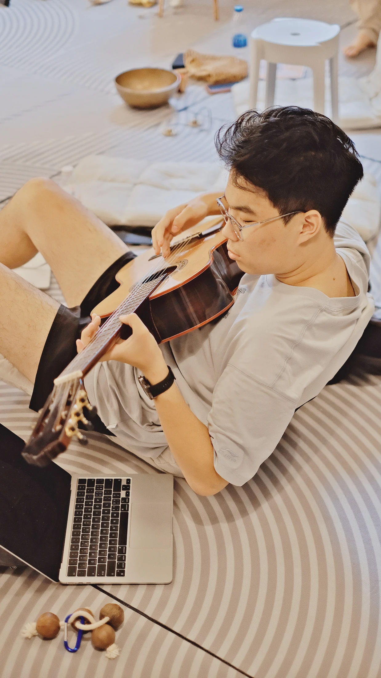 A participant using guitar as part of a reflective creative practice
