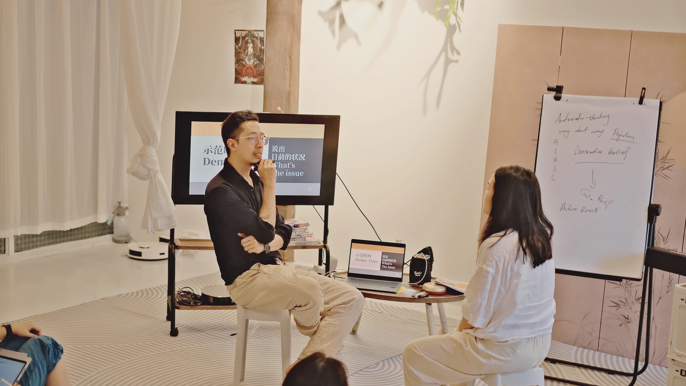 A facilitator demonstrating therapeutic practice in a small learning setting